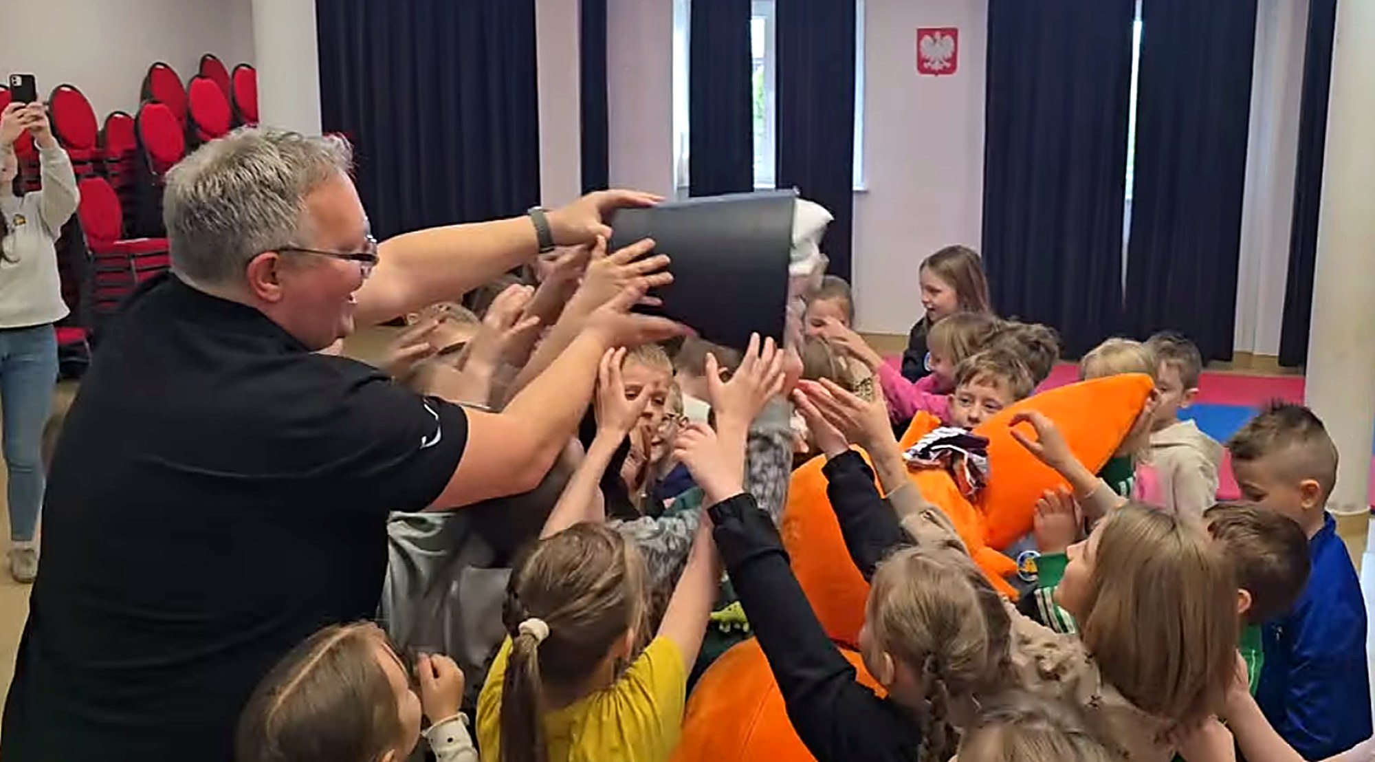 Dzieci wyciągające ręce podczas aktywnego zadania na spotkaniu z Fenkiem